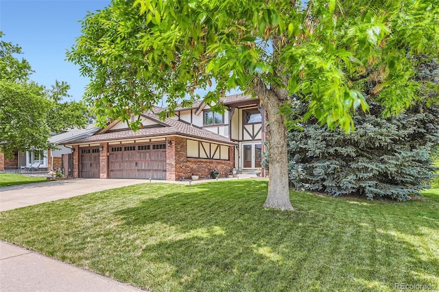 7863 W Friend Dr, Littleton, CO 80128 - tudor house featuring an attached garage, a front yard, brick siding, and concrete driveway