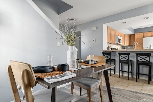 dining area featuring light tile patterned floors and recessed lighting