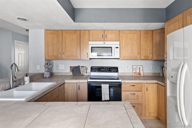 kitchen with tile countertops, white appliances, a peninsula, and a sink