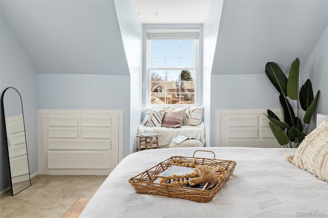 carpeted bedroom featuring lofted ceiling