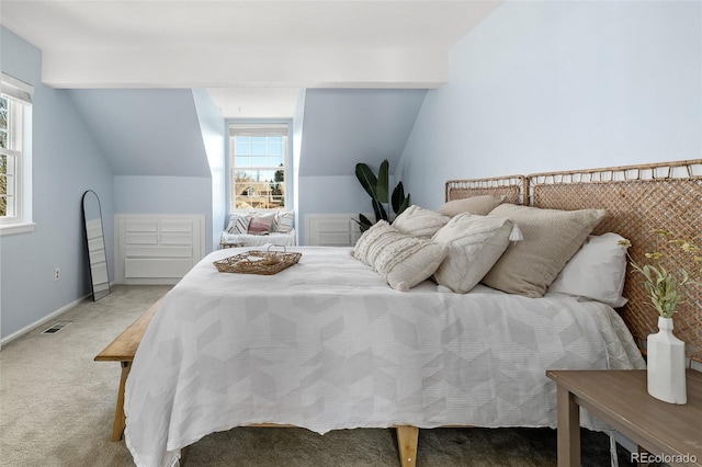 carpeted bedroom featuring baseboards, multiple windows, visible vents, and vaulted ceiling