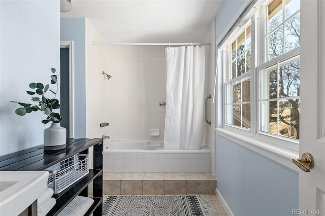 full bathroom with baseboards, tiled shower / bath, and tile patterned floors