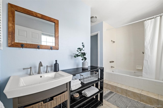 full bathroom with tiled shower / bath combo, tile patterned flooring, and vanity