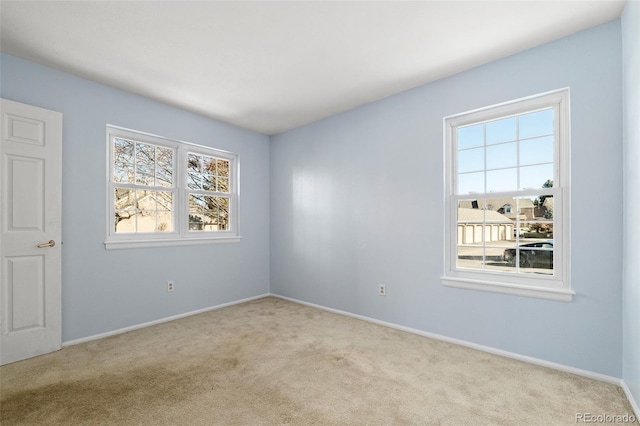 unfurnished room with carpet and baseboards