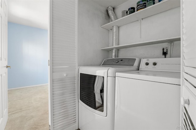 washroom with carpet floors, laundry area, and washer and dryer