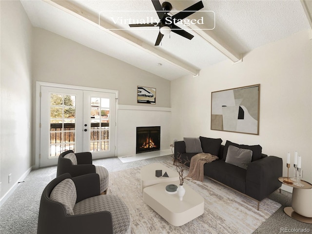 carpeted living room featuring lofted ceiling with beams, a textured ceiling, french doors, and ceiling fan