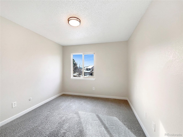 carpeted empty room with a textured ceiling