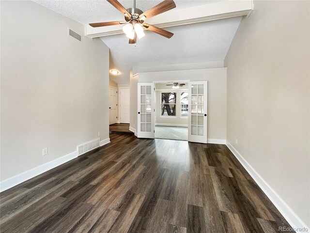 unfurnished living room featuring dark hardwood / wood-style flooring, ceiling fan, a textured ceiling, french doors, and vaulted ceiling