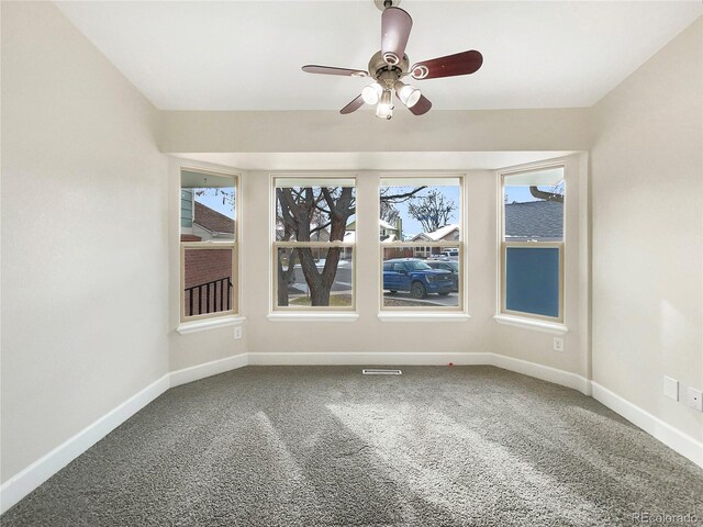 carpeted empty room featuring ceiling fan