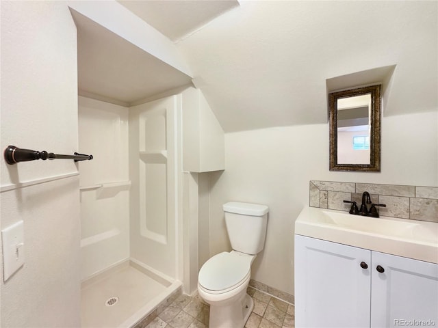 bathroom with tile flooring, toilet, vanity, and walk in shower