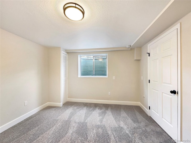 unfurnished room with dark colored carpet