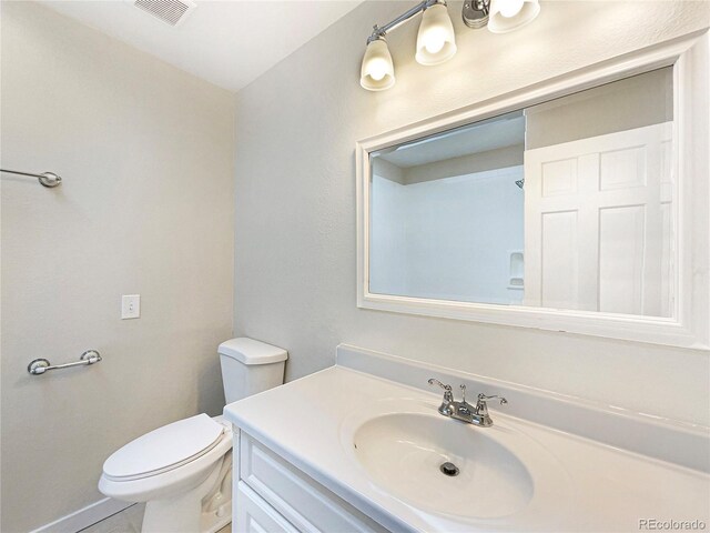 bathroom with toilet and oversized vanity