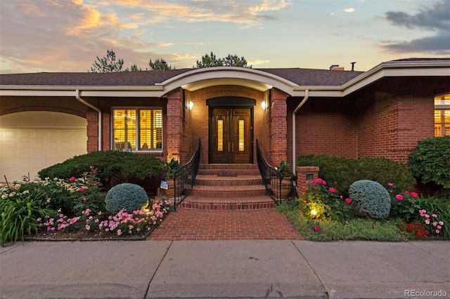 view of exterior entry at dusk