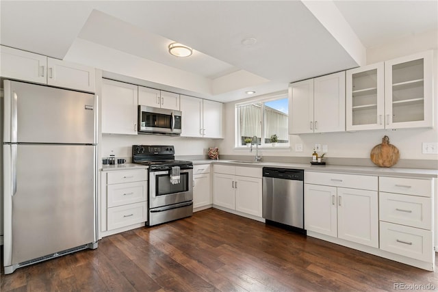 12708 W Virginia Ave, Lakewood, CO 80228 - kitchen with appliances with stainless steel finishes, a sink, white cabinets, and glass insert cabinets