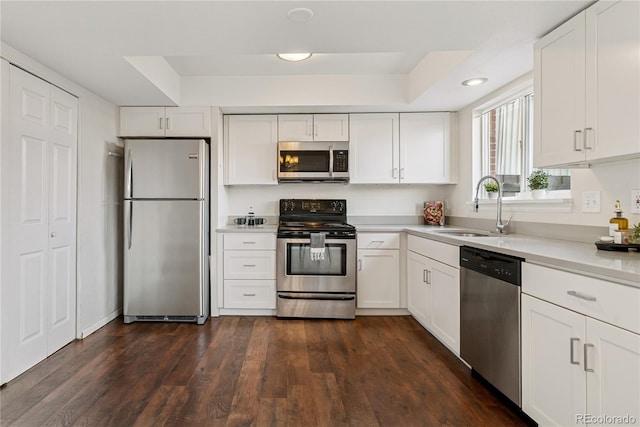 12708 W Virginia Ave, Lakewood, CO 80228 - kitchen with appliances with stainless steel finishes, a sink, white cabinetry, light countertops, and recessed lighting