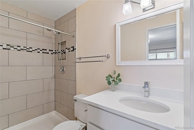 12708 W Virginia Ave, Lakewood, CO 80228 - bathroom featuring a tile shower, vanity, and toilet