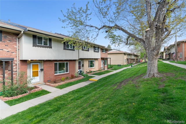 12708 W Virginia Ave, Lakewood, CO 80228 - multi unit property with brick siding, a front yard, and a residential view