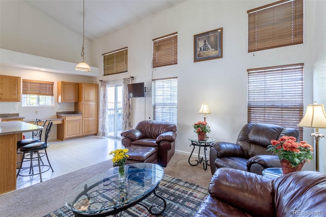 carpeted living room featuring high vaulted ceiling