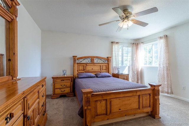 bedroom with ceiling fan and light carpet