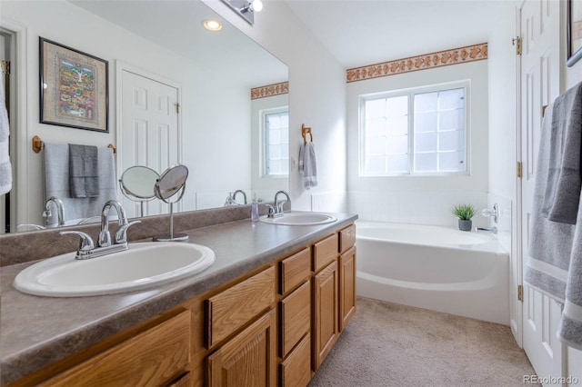 bathroom with vanity and a bathing tub