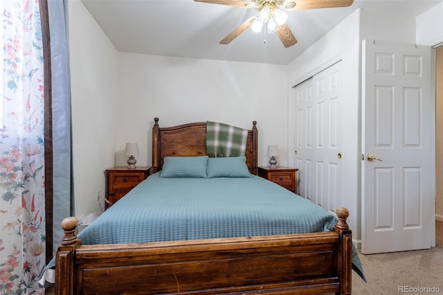 carpeted bedroom featuring ceiling fan and a closet