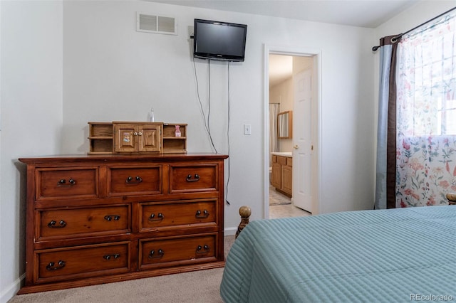 carpeted bedroom featuring connected bathroom