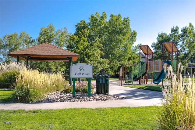 view of home's community with a lawn and a playground