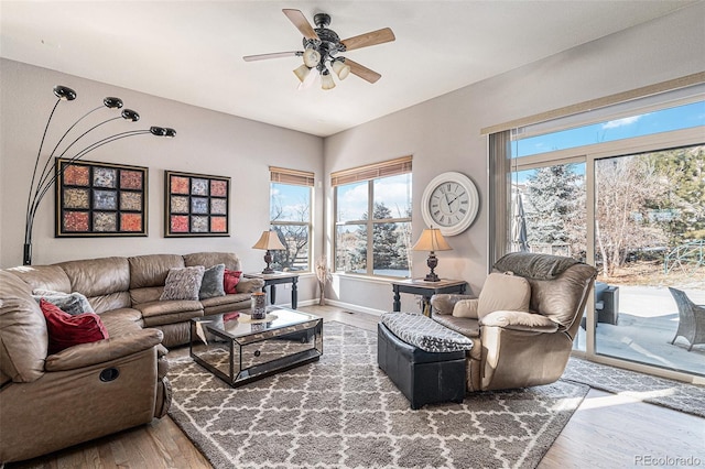 living room featuring wood-type flooring and ceiling fan