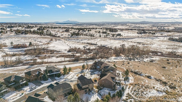 snowy aerial view featuring a mountain view