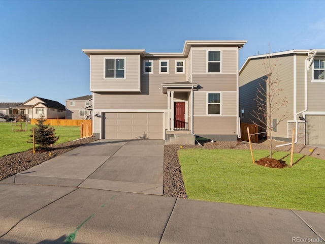 view of front of property featuring a front yard and a garage