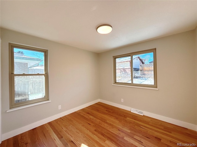 unfurnished room with light hardwood / wood-style floors