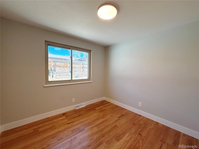 spare room featuring light hardwood / wood-style flooring