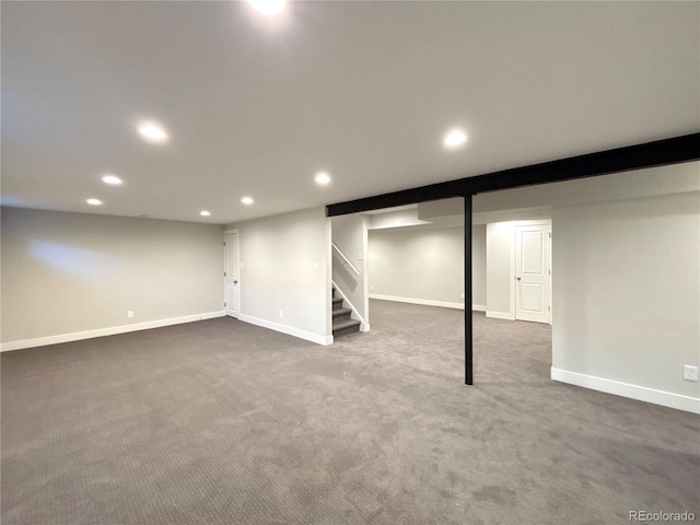 basement featuring dark colored carpet