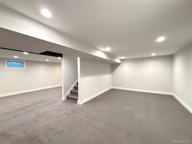 basement featuring dark carpet