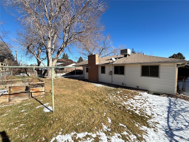 snow covered property featuring a yard and cooling unit