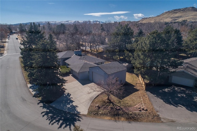 aerial view with a view of trees and a mountain view