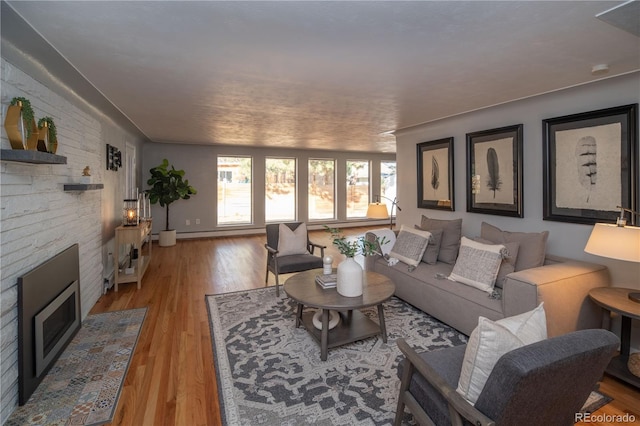 living area with a fireplace and light wood-style floors