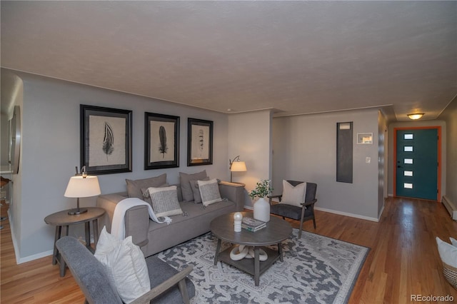 living area featuring wood finished floors and baseboards