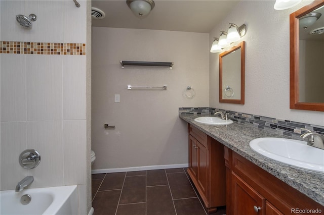 bathroom featuring a sink, visible vents, tasteful backsplash, and tile patterned floors