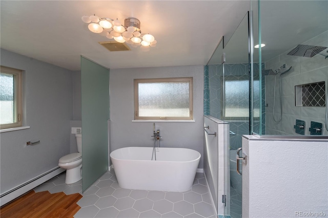 bathroom featuring visible vents, a soaking tub, tile patterned flooring, baseboard heating, and walk in shower