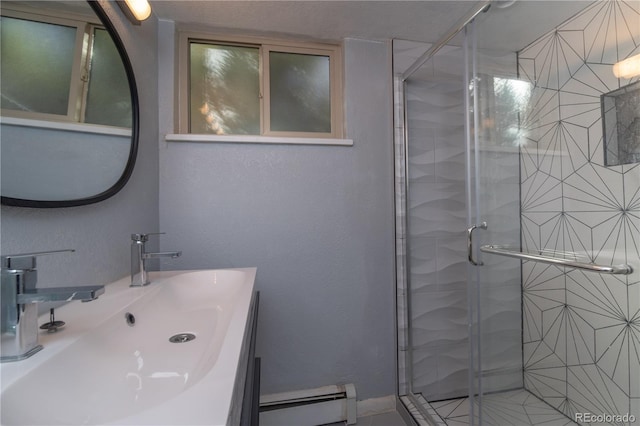 bathroom featuring baseboard heating, a shower stall, and vanity