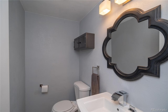 bathroom featuring toilet and a sink