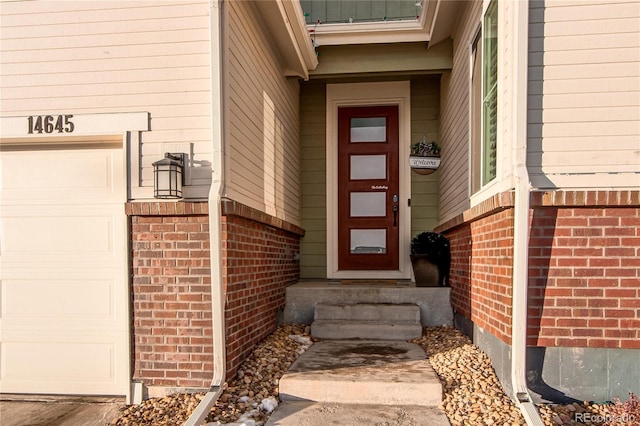 doorway to property with a garage