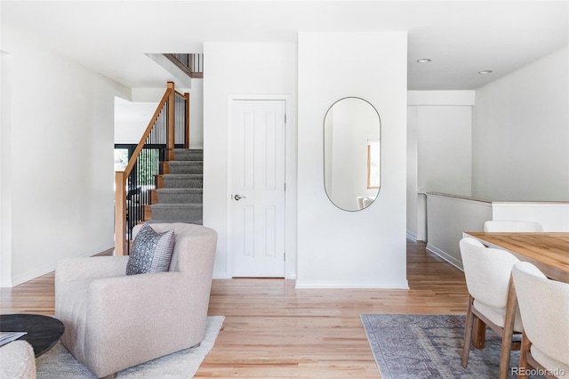 1272 S Milwaukee St, Denver, CO 80210 - living area featuring light wood finished floors, stairway, and recessed lighting