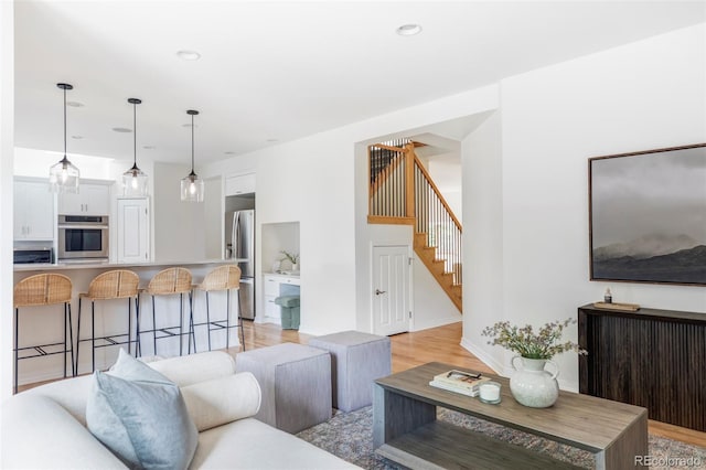 1272 S Milwaukee St, Denver, CO 80210 - living area featuring stairway, light wood finished floors, and recessed lighting
