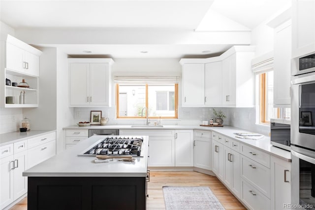 1272 S Milwaukee St, Denver, CO 80210 - kitchen featuring stainless steel gas stovetop, healthy amount of natural light, decorative backsplash, white cabinetry, and recessed lighting