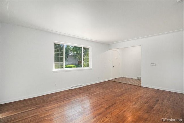 empty room with dark hardwood / wood-style floors