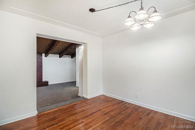 spare room with hardwood / wood-style floors, a notable chandelier, wood ceiling, and beamed ceiling