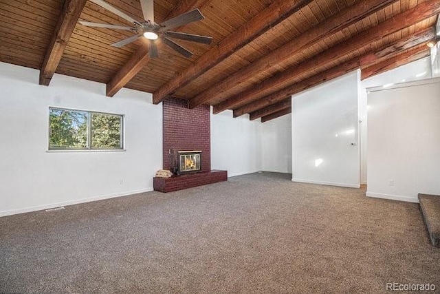 unfurnished living room with beamed ceiling, wooden ceiling, a fireplace, and carpet