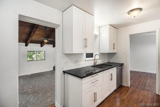 kitchen featuring beam ceiling, ceiling fan, sink, and white cabinets